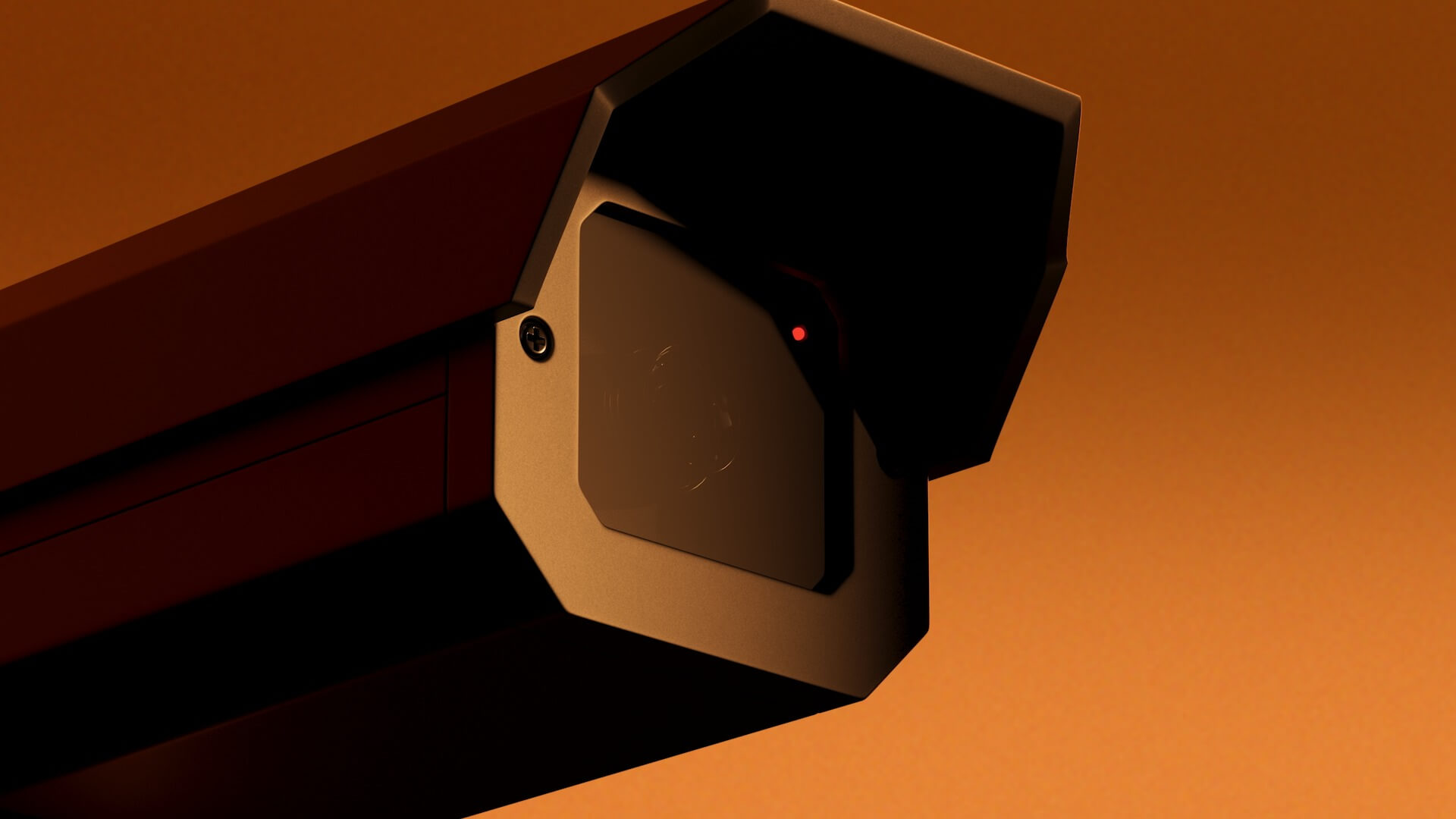 Close-up shot of a security camera with it's recording light switched on.